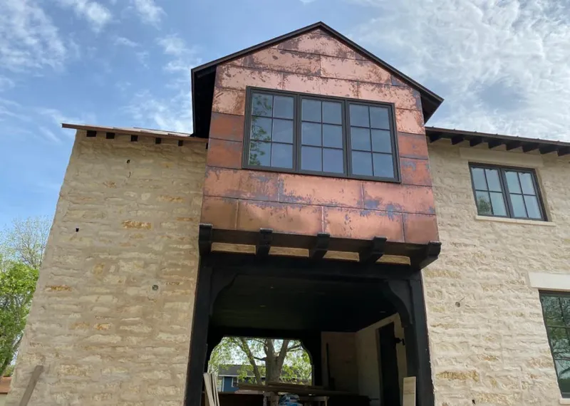 Copper metal panel facade on a stone building for Skylight Installation in Bluffdale